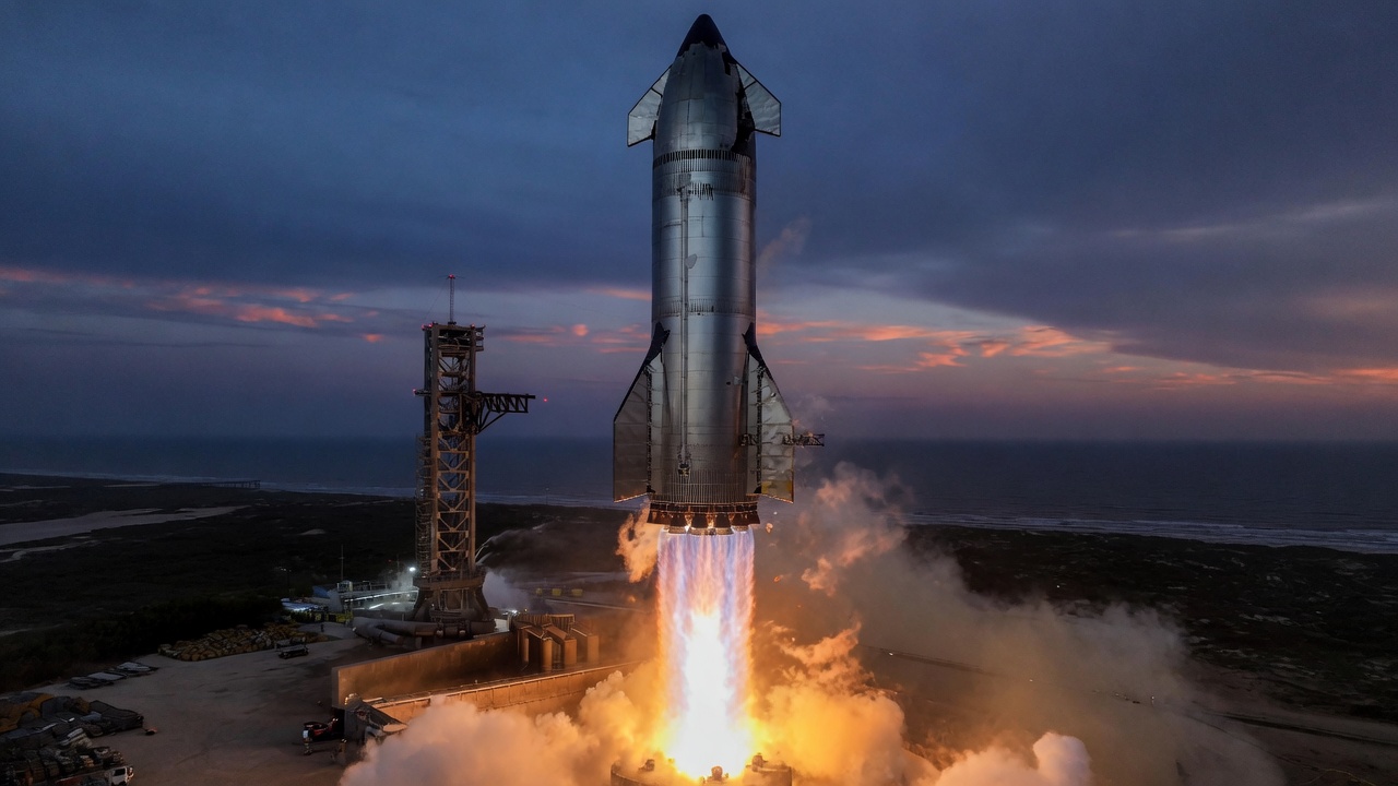 Stainless ship lifting off beside a launch tower